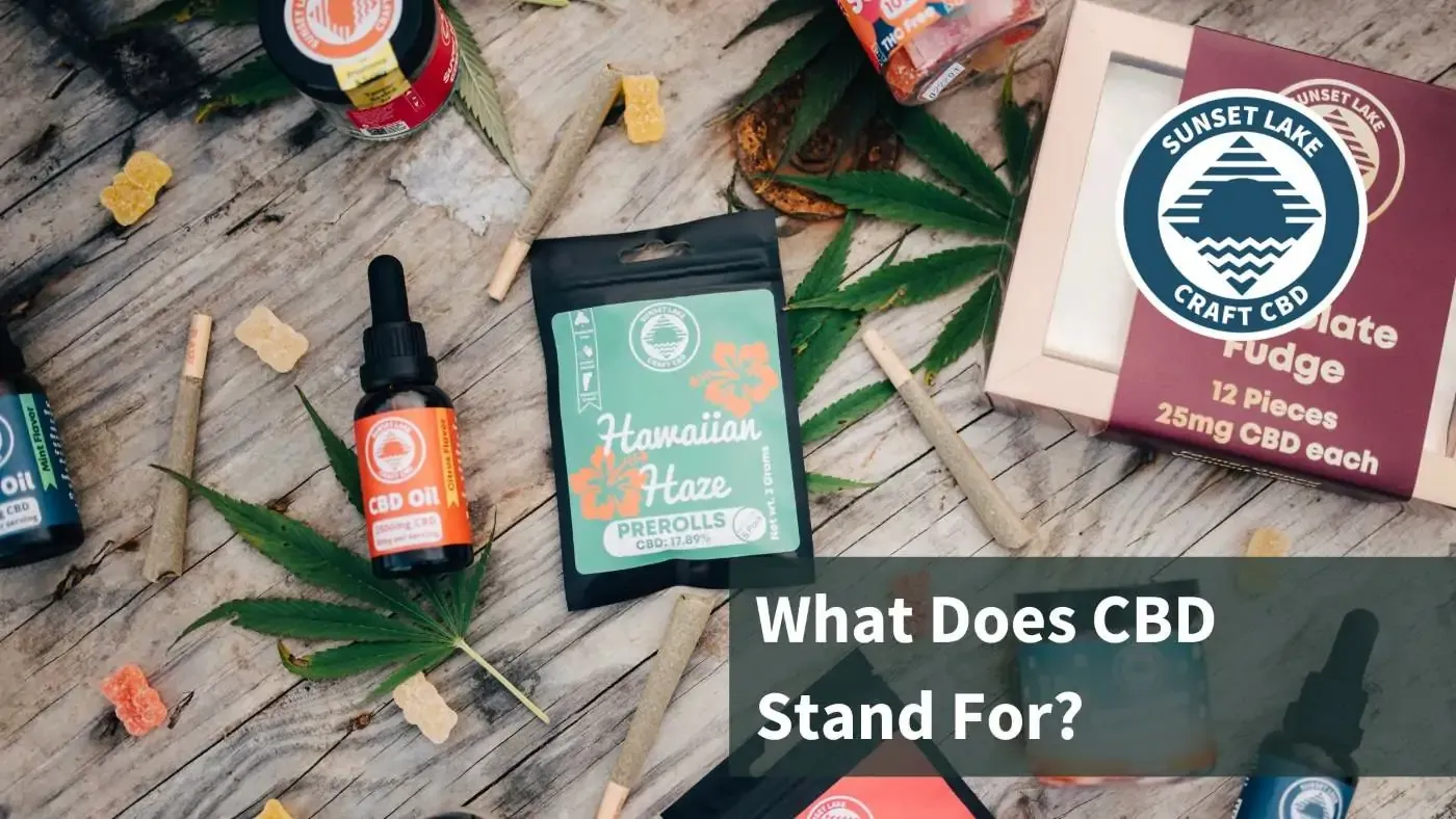 CBD products laid out on a table. Text reads "What Does CBD Stand For?"