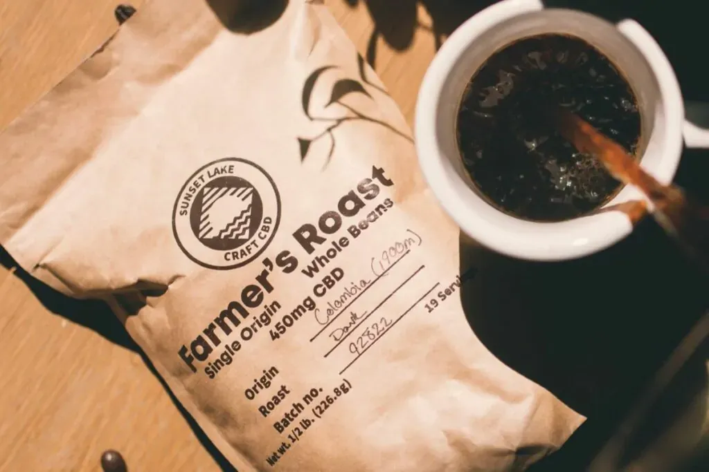 A cup of Sunset Lake CBD Coffee next to a one pound bag of beans. 