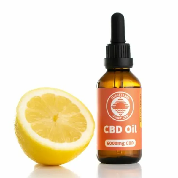 Citrus-flavored 6,000mg CBD oil next to a lemon half