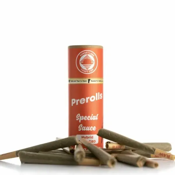 A tube of Special Sauce Prerolls surrounded by pre-rolled joints