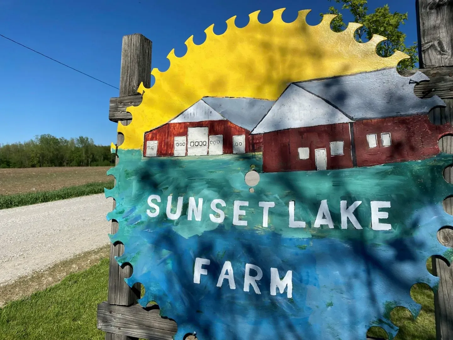 Sunset Lake Farm sign painted on a large saw blade